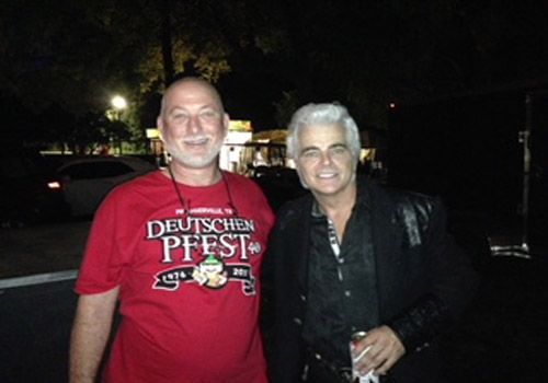A man wearing a red shirt that says deutschen pfest