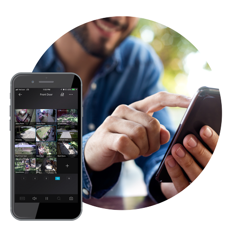 A man is sitting at a table using a cell phone