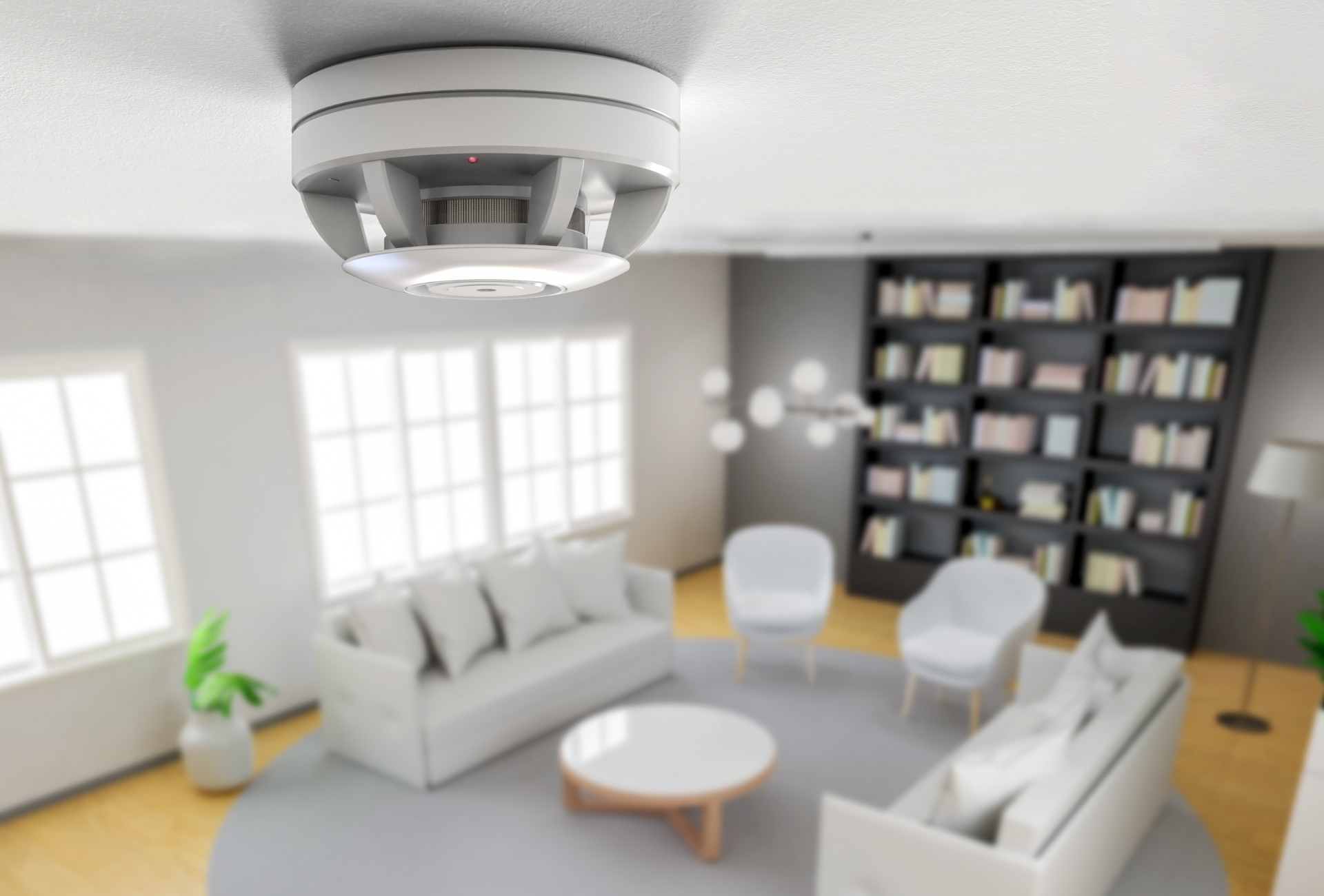 A living room with a smoke detector hanging from the ceiling.